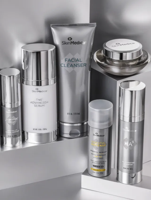 Skincare bottles and a facial cleanser on a shelf