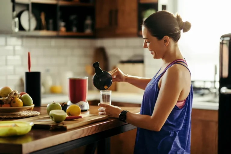 Woman preparing a healthy drink in her kitchen